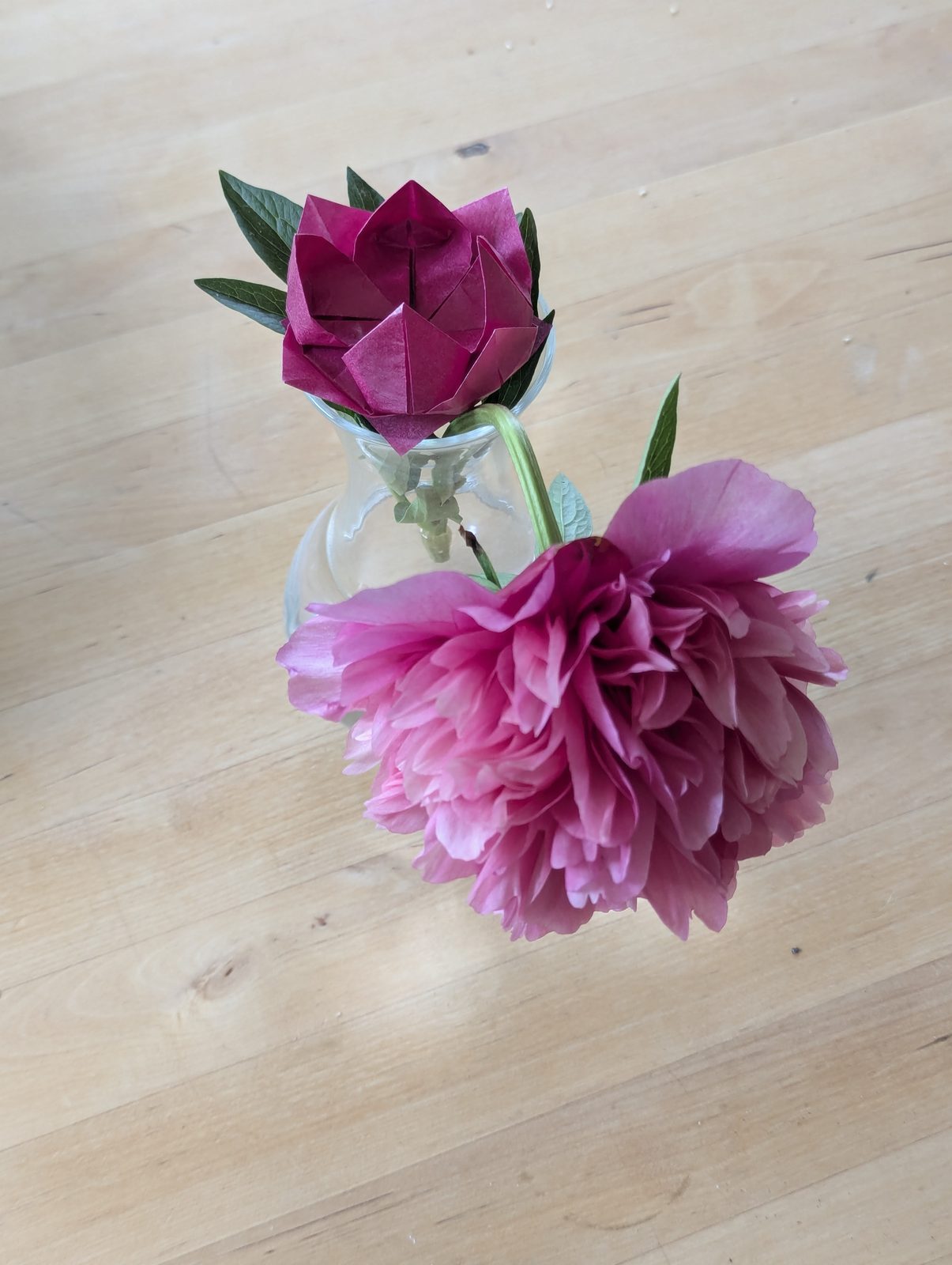 Origami lotus and pink peony in a glass vase