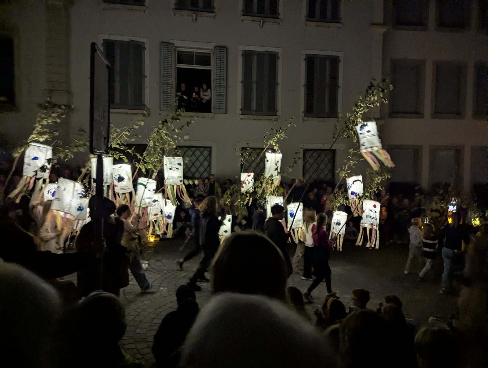 Lantern parade at night in front of an old building